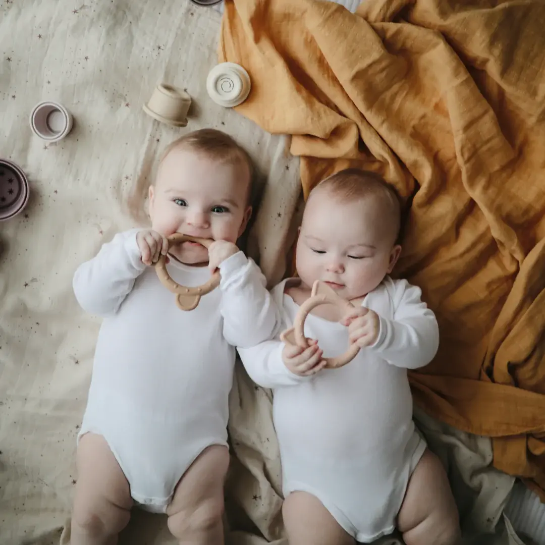 Mushie organic cotton swaddle in fall yellow at Seb and I