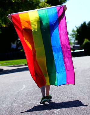 person-walking-while-holding-rainbow-col