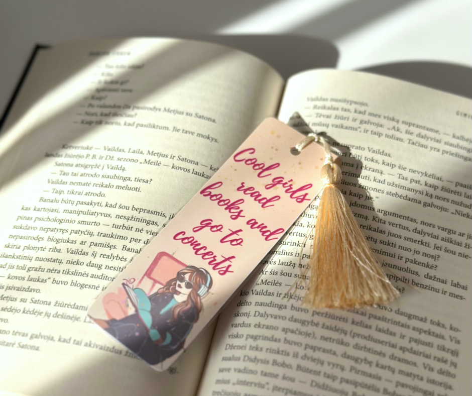 Bookmark with the quote 'Cool girls read books and go to concerts' displayed on the open book