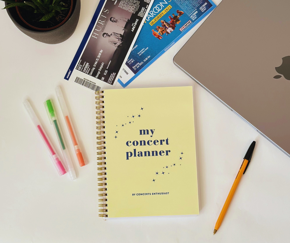 Planner lying on desk with pen and tickets