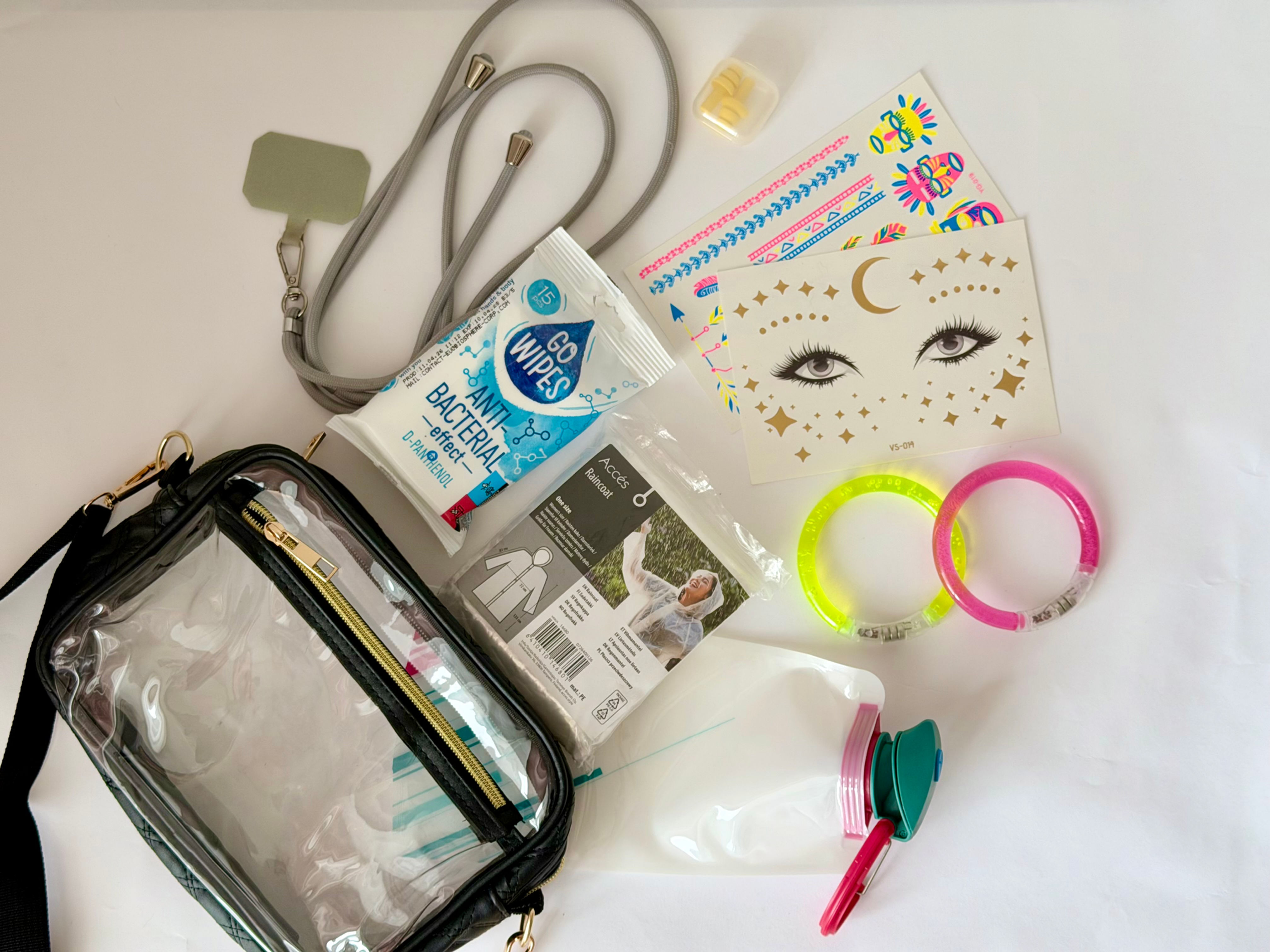 Clear concert gift bag with black details displayed alongside concert essentials