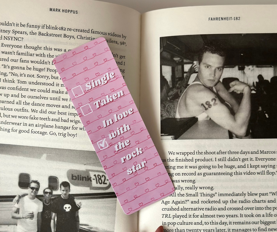 Pink ‘Heart on Tour’ bookmark from the Pink Fangirl Bookmark Collection inside an open book