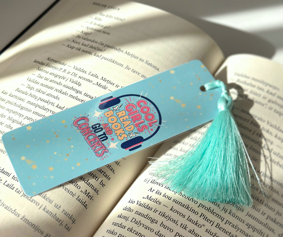 “Cool Girls Read Books and Go to Concerts” bookmark on a book