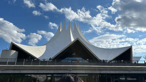 Exterior view of Tempodrom in Berlin, featuring its distinctive white tent-like roof structure and modern architectural design.