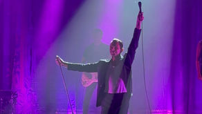 Theo Hutchcraft performing on stage during the Hurts concert at Sigulda Medieval Castle as part of the 15 Years of Happiness Tour 2025