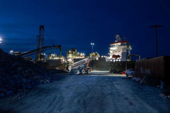 Maritime Infrastructure: Evening shot of front-loader loading ore onto a ship at Sheet Harbour - Nova Scotia