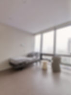 Relaxing recovery room inside a luxury Korean aesthetic clinic, soft lighting and single bed setup