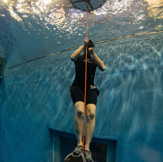 Freediver pinching nose and equalizing before dive at poolside in Korea