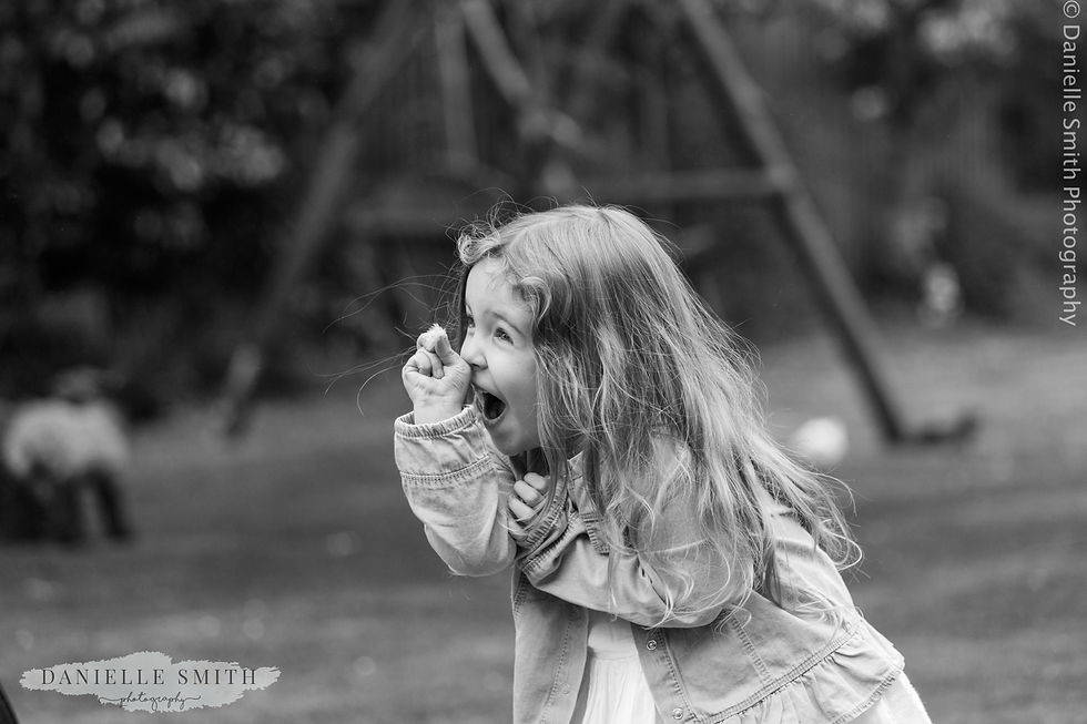 little girl picking flowers in garden