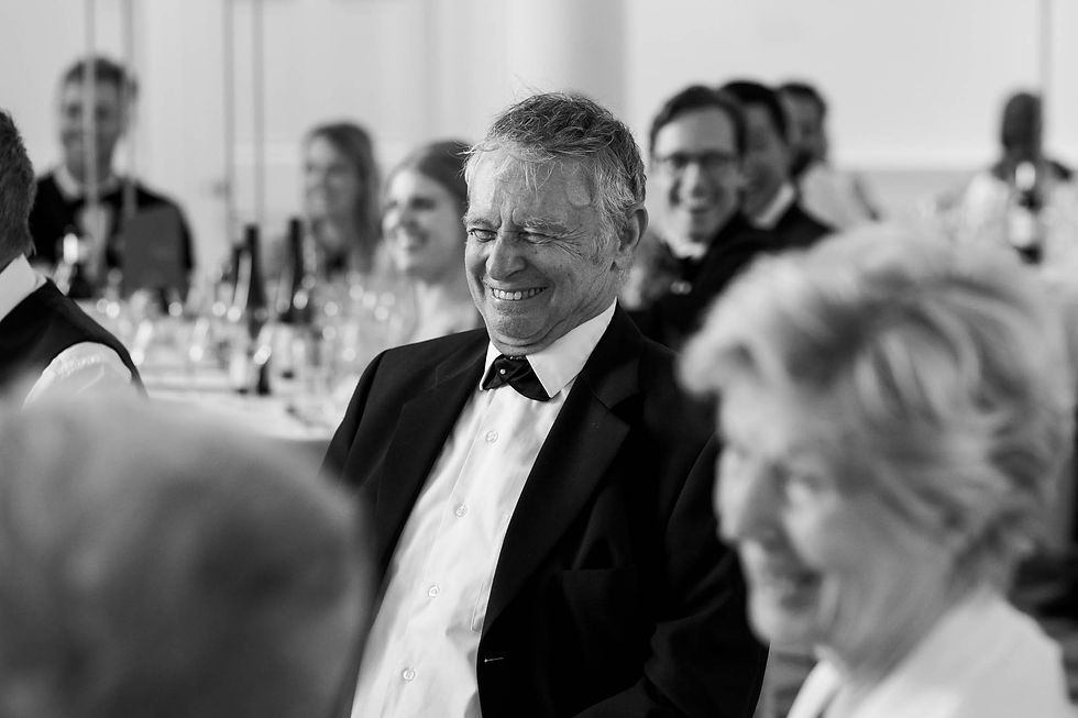 older wedding guest laughing