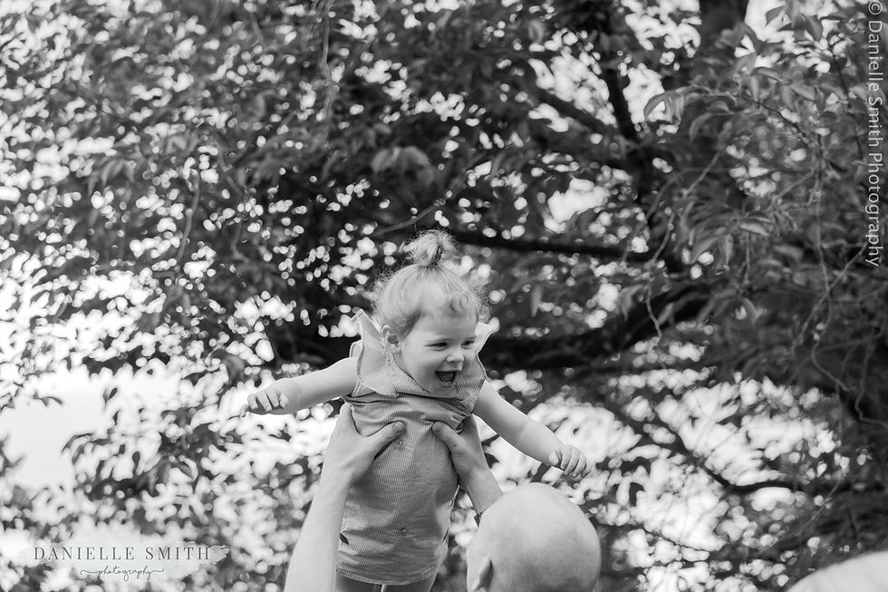 little girl being thrown up in air