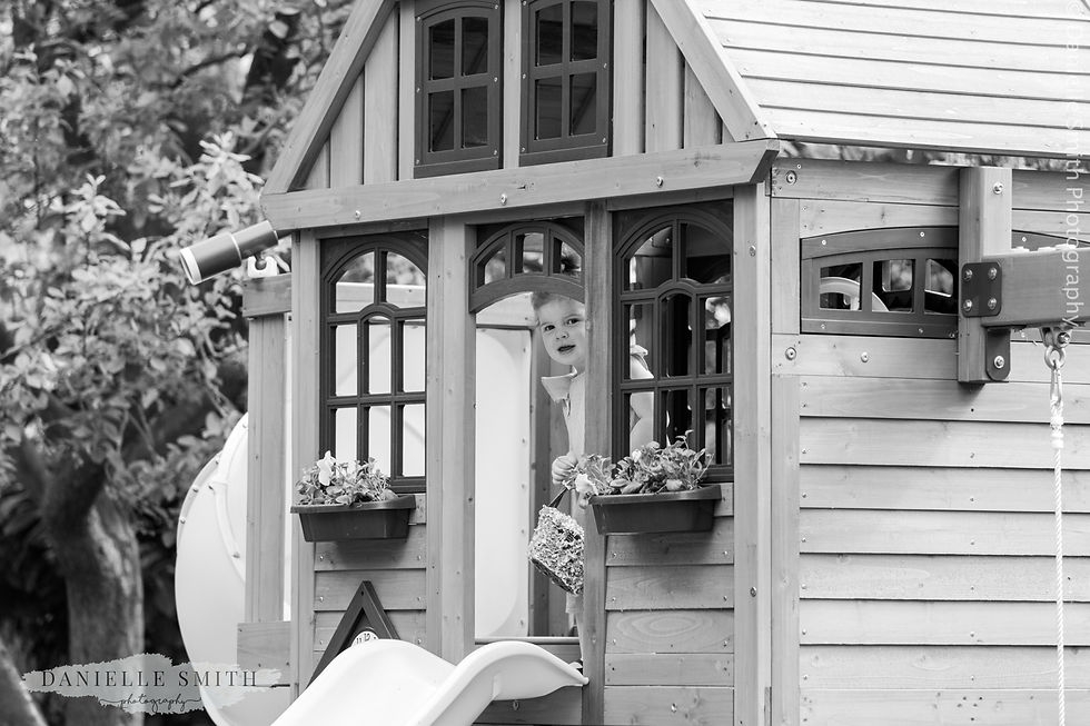little girl peeking out of her play house