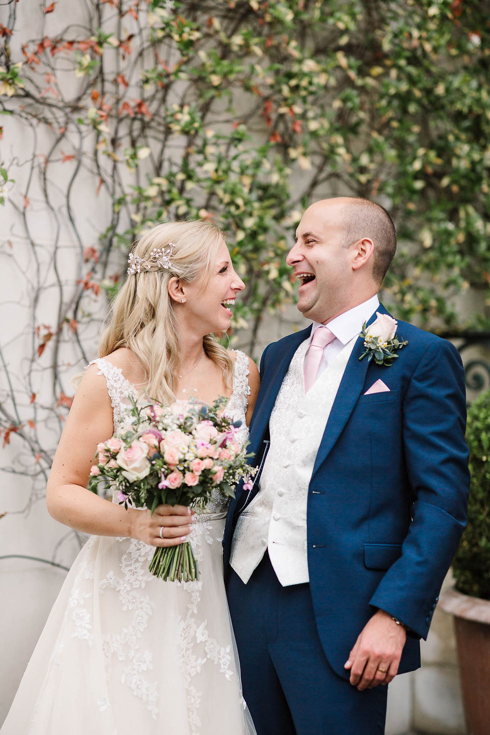 bride and groom laughing on terrace at RAC club wedding