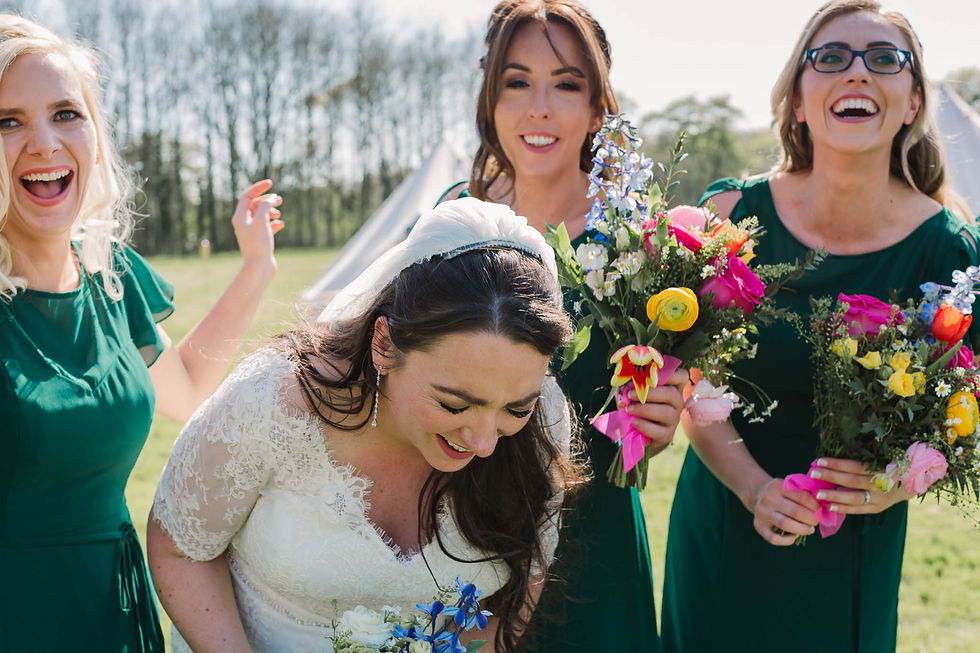 bride and bridesmaids laughing