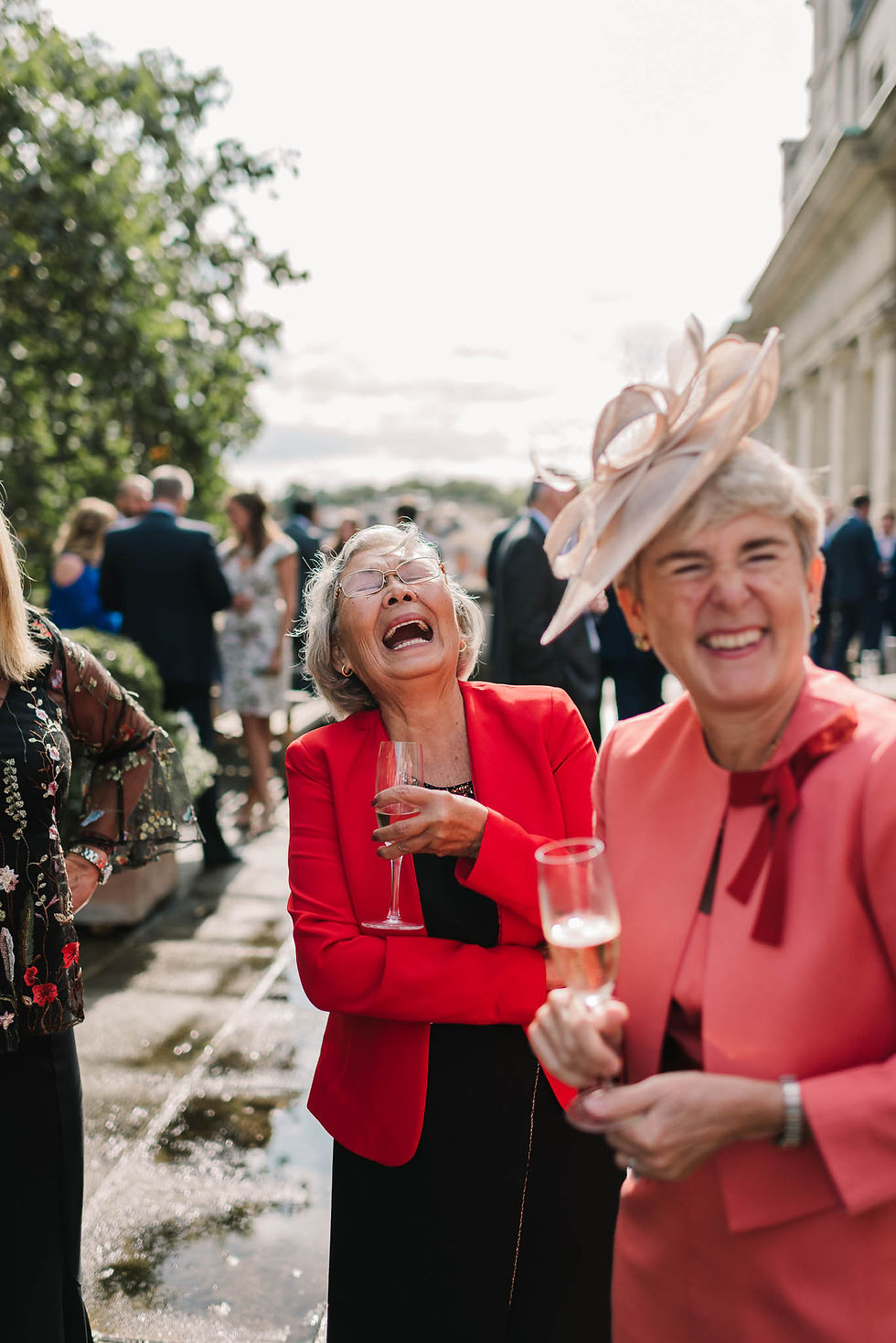 wedding guests laughing - Elegant London Wedding at the Royal Automobile Club