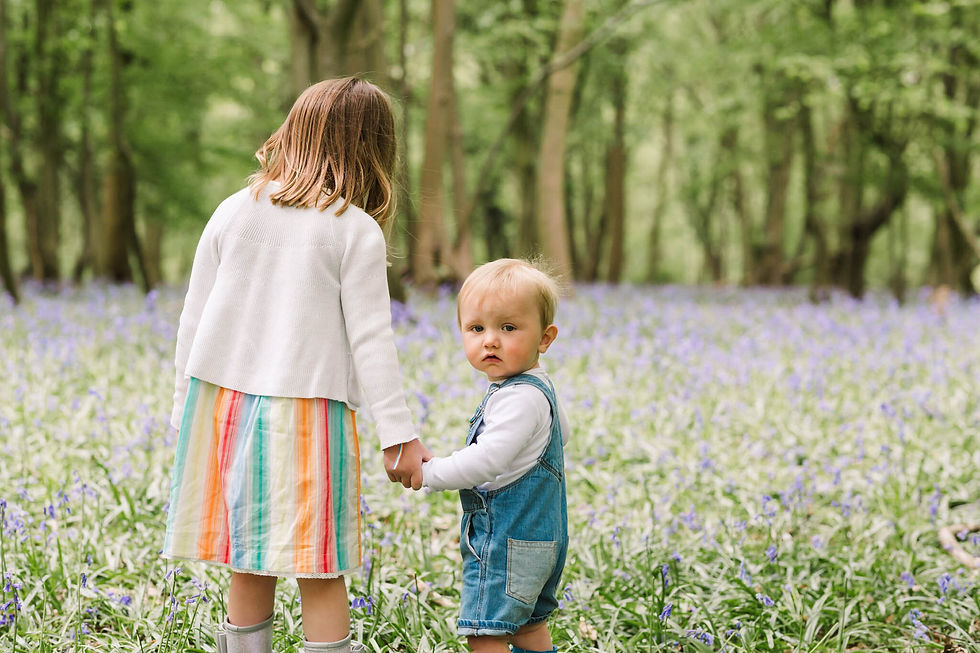 little girl holding brothers hand