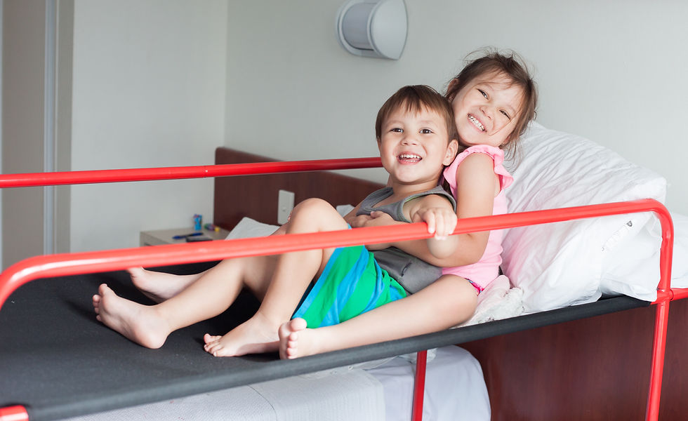 Brooklyn and Havanah smiling on their camp bunk beds in Hope Cottage, Nepean Hospital - Erin Michele Thomson