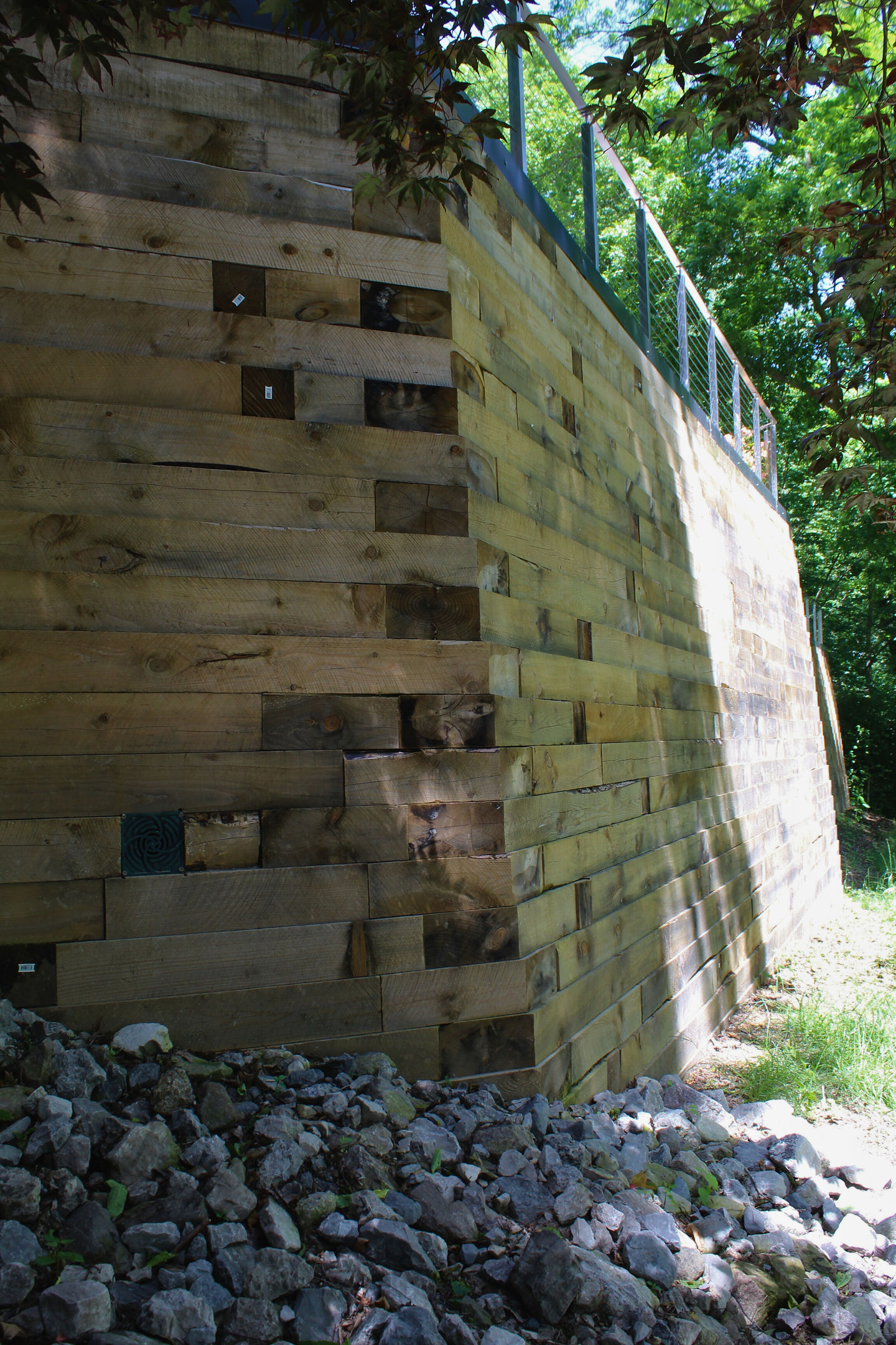 Retaining wall construction detail with stone base and drainage