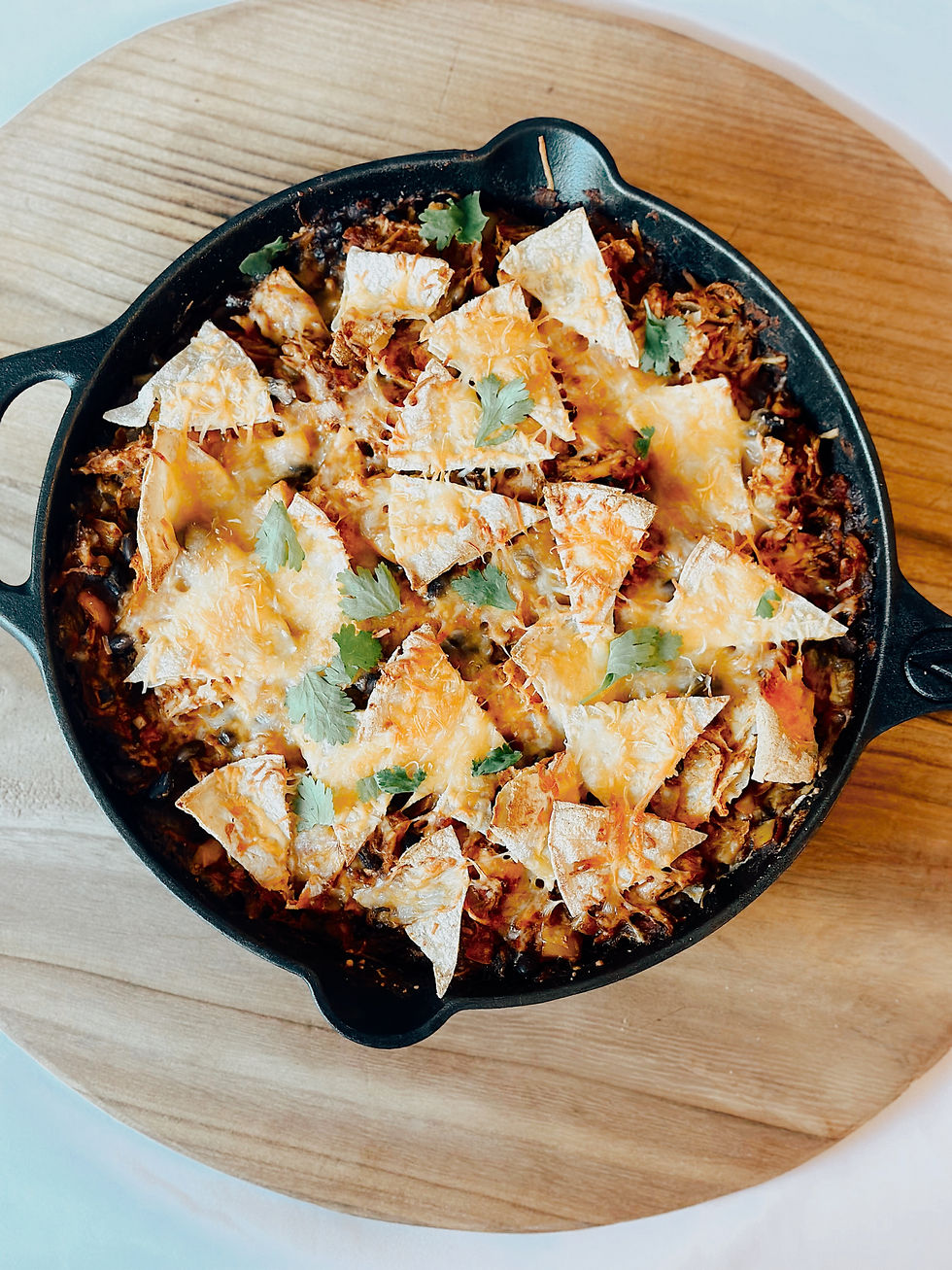 deconstructed enchiladas made with black beans, shredded chicken, and corn tortillas