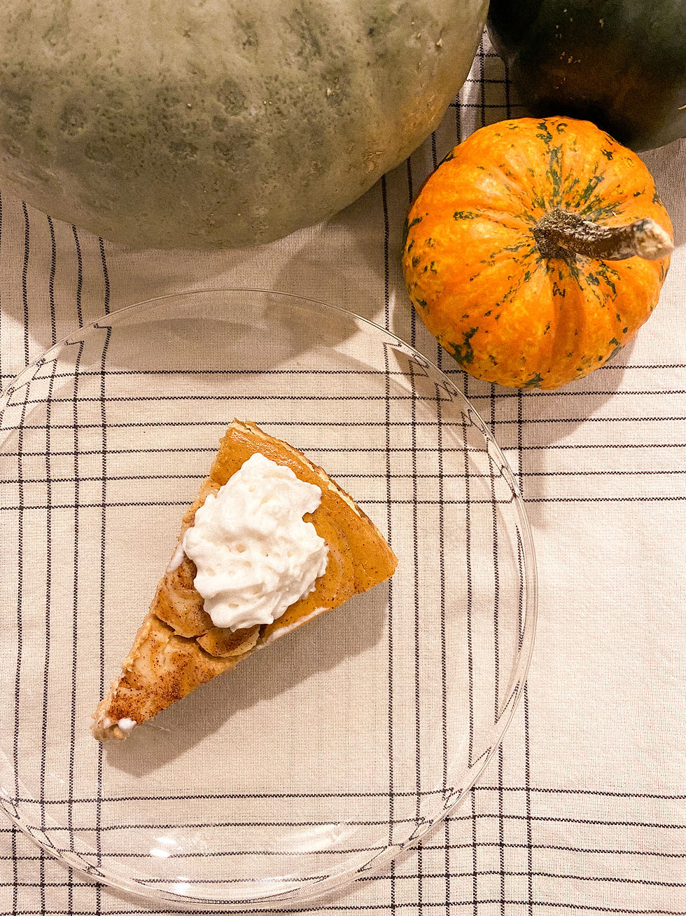 a gluten free and dairy free pumpkin cheesecake with cinnamon swirls and dairy free whipped cream