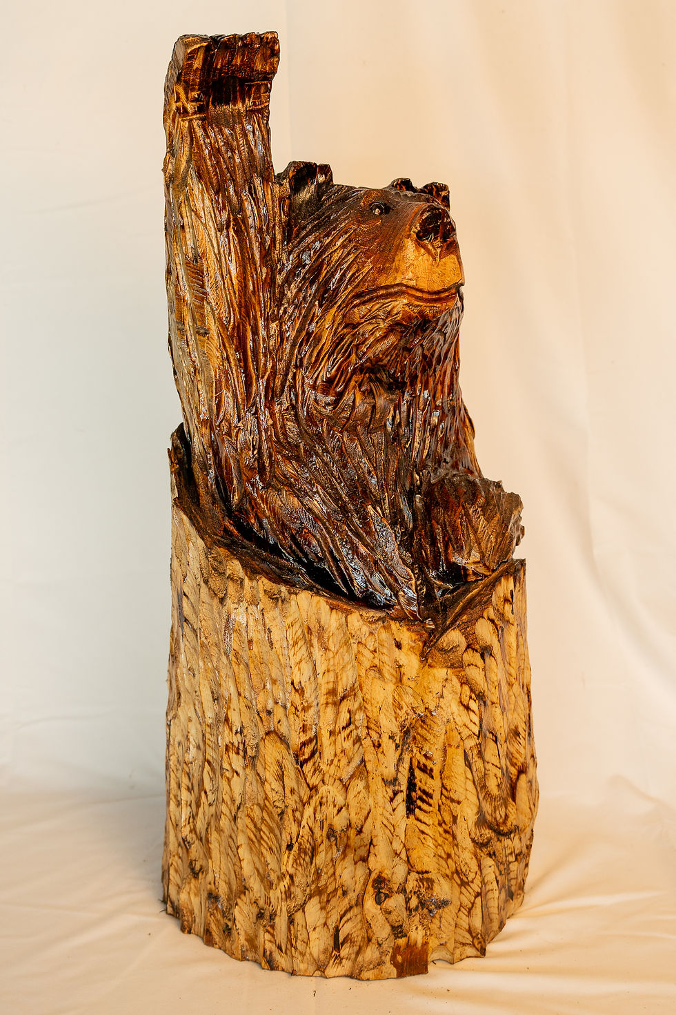 Full of personality and rustic charm, this playful waving bear carving brings the spirit of the Pacific Northwest wilderness