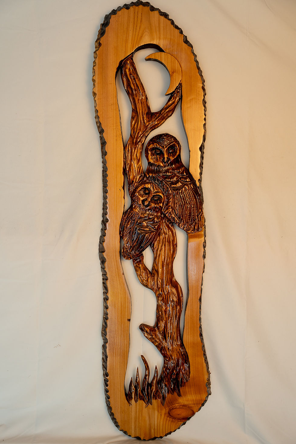 woodland scene inspired by the forests of the Pacific Northwest, featuring a mother owl and owlets carved with rustic detail