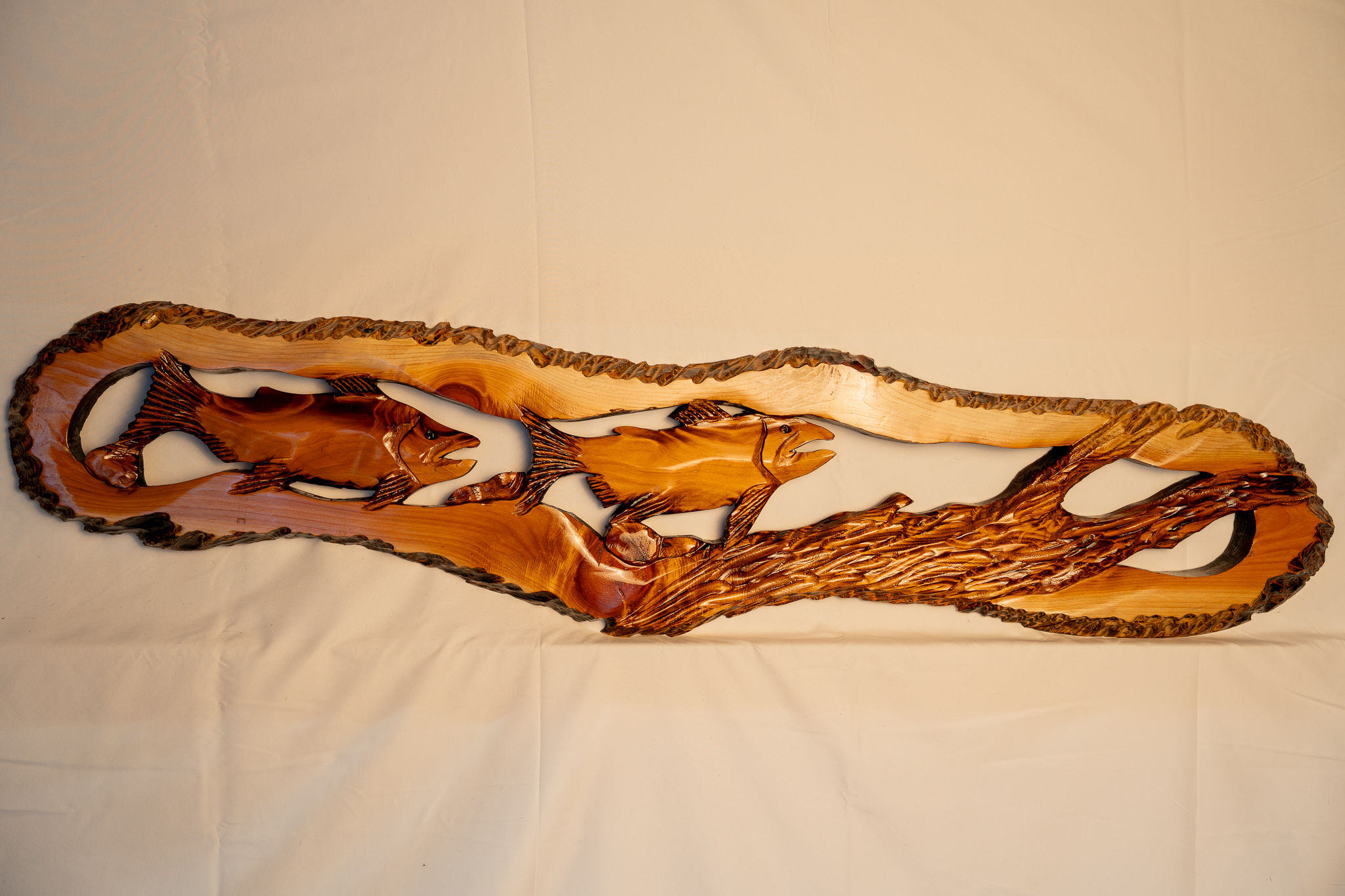 Handcrafted salmon carving celebrates the movement and life of Northwest rivers.