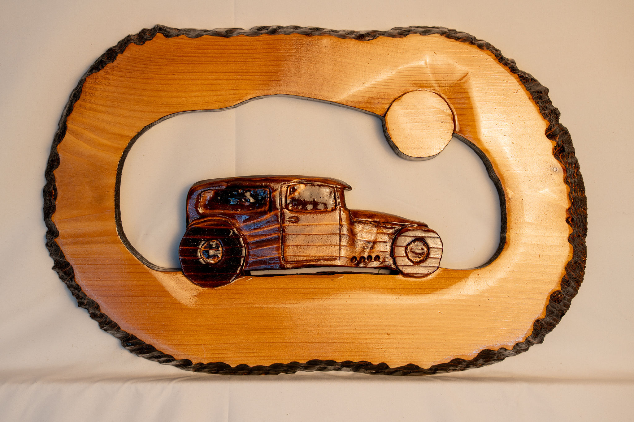 Rustic chainsaw artistry with classic automotive inspiration, this hot rod carving delivers vintage style with hand