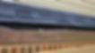 Brown gutter with damaged section under asphalt roof