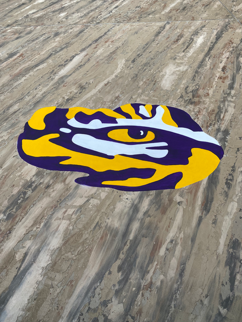 Abstract yellow and purple decorative design on concrete