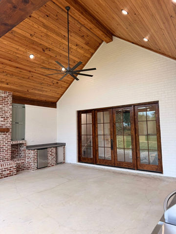 Outdoor patio with vaulted wood ceiling and kitchen