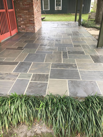 Wet flagstone outdoor patio by Louisiana contractor