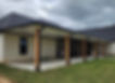 Covered patio with black gutters and wooden posts