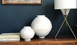Ian-burgess-Ceramic-Moon-Jars-sitting-on-a-wooden-sideboard.jpg