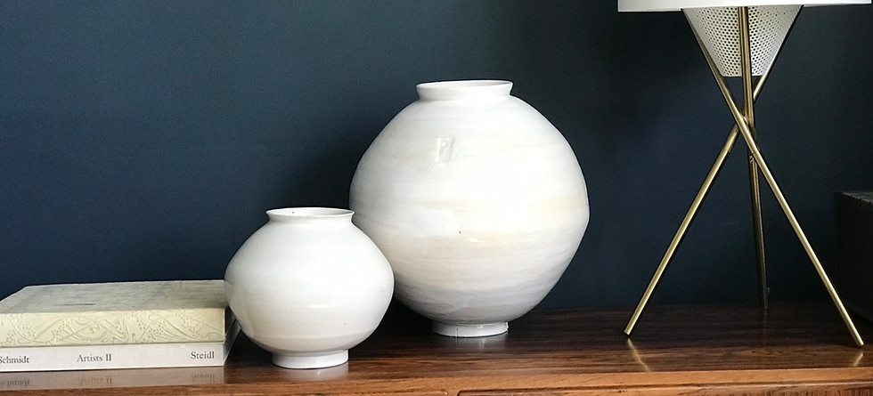 Ian-burgess's-moon-jars-displayed-on-a-wooden-sideboard