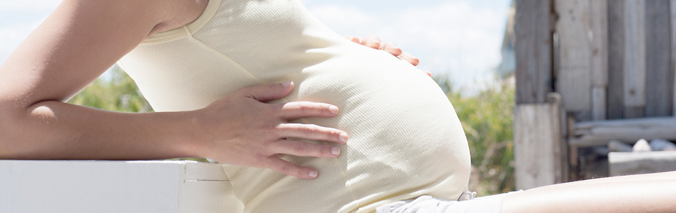 Pregnant woman smiling outdoors