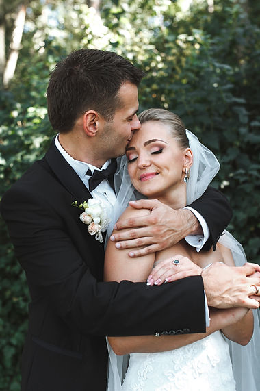 groom-hugging-bride-kissing-her-forehead.jpg