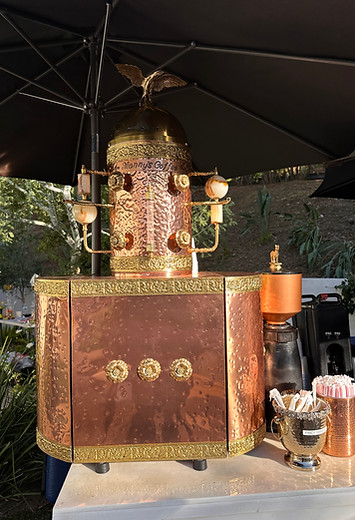 A full copper structure with gold and marble accessories along with a gold eagle at the top.