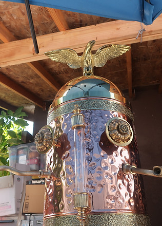A cylindrical copper structure with a gold eagle at the top.