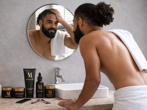 A man in the bathroom looking in the mirror during a morning grooming routine