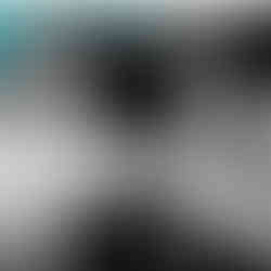 Image of a girl in an eye mask, her head is on aa white pillow. There re headphones on thee bed in front of her. She has long hair.