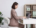 Office worker maintaining proper posture at desk to protect spine health.