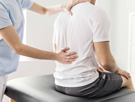 Healthcare provider evaluating a patient’s spine as part of interventional pain management care.