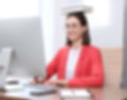 A professional sitting with correct posture and relaxed shoulders, maintaining spine health.