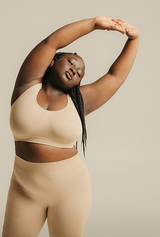 Attractive-African-plus-size-woman-in-underwear-radiating-self-love-while-standing-on-stud