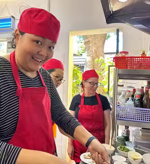 Tourists cooking their own traditional Khmer food