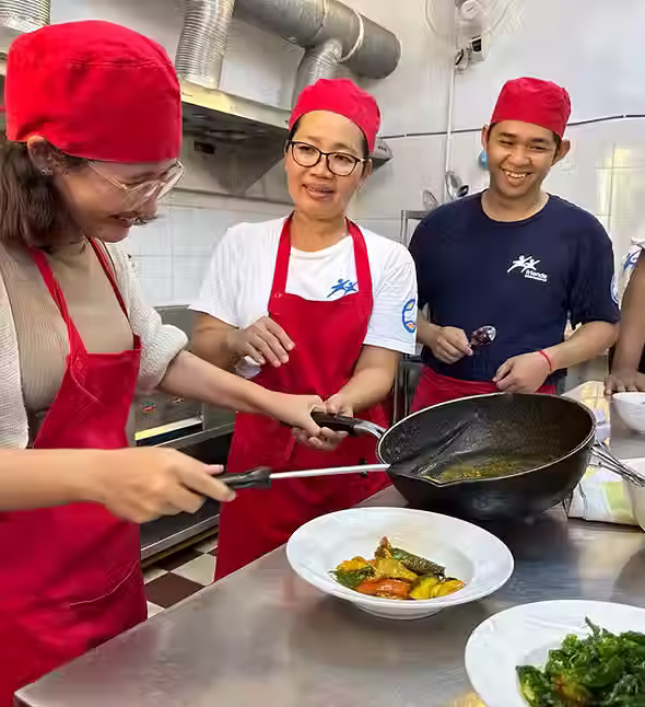 Students cooking Khmer food during class at F3, Phnom Penh