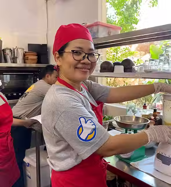 ChildSafe Experiences teacher blends ingredients for cooking class