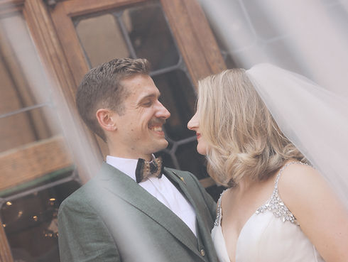 Bride and groom smiling at each other under a white veil Best Place at Pabst Brewery