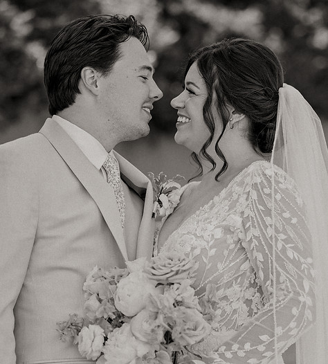 Black and White of bride and groom embracing at a wedding planned by Indigo Moon Events